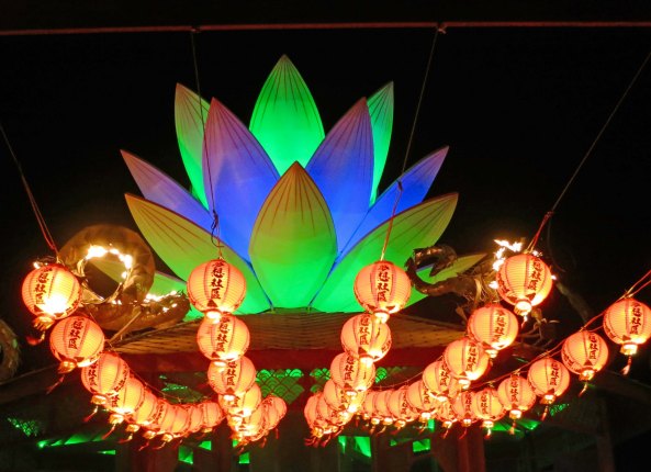 A view of the Mazu Temple at night displaying its lantern and lotus.