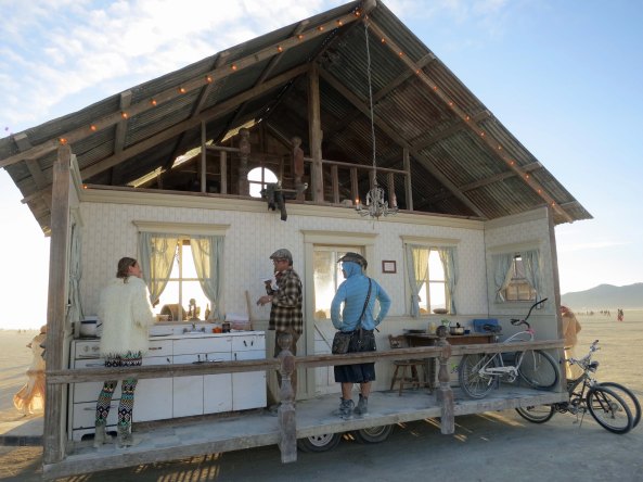One of my favorite buildings is this 'mobile home' pulled by a tractor. You never know where it will show up. This side features a 50s style kitchen that cooks and gives away cookies. The other side is a free bar.