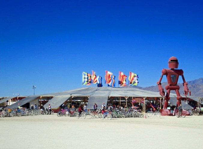 The Center Camp Cafe at Burning Man 2015. The flying flags can be seen from most places on the Playa and in Black Rock City, serving as a beacon for lost Burners. I've used them many times, especially at night when they are lit up.