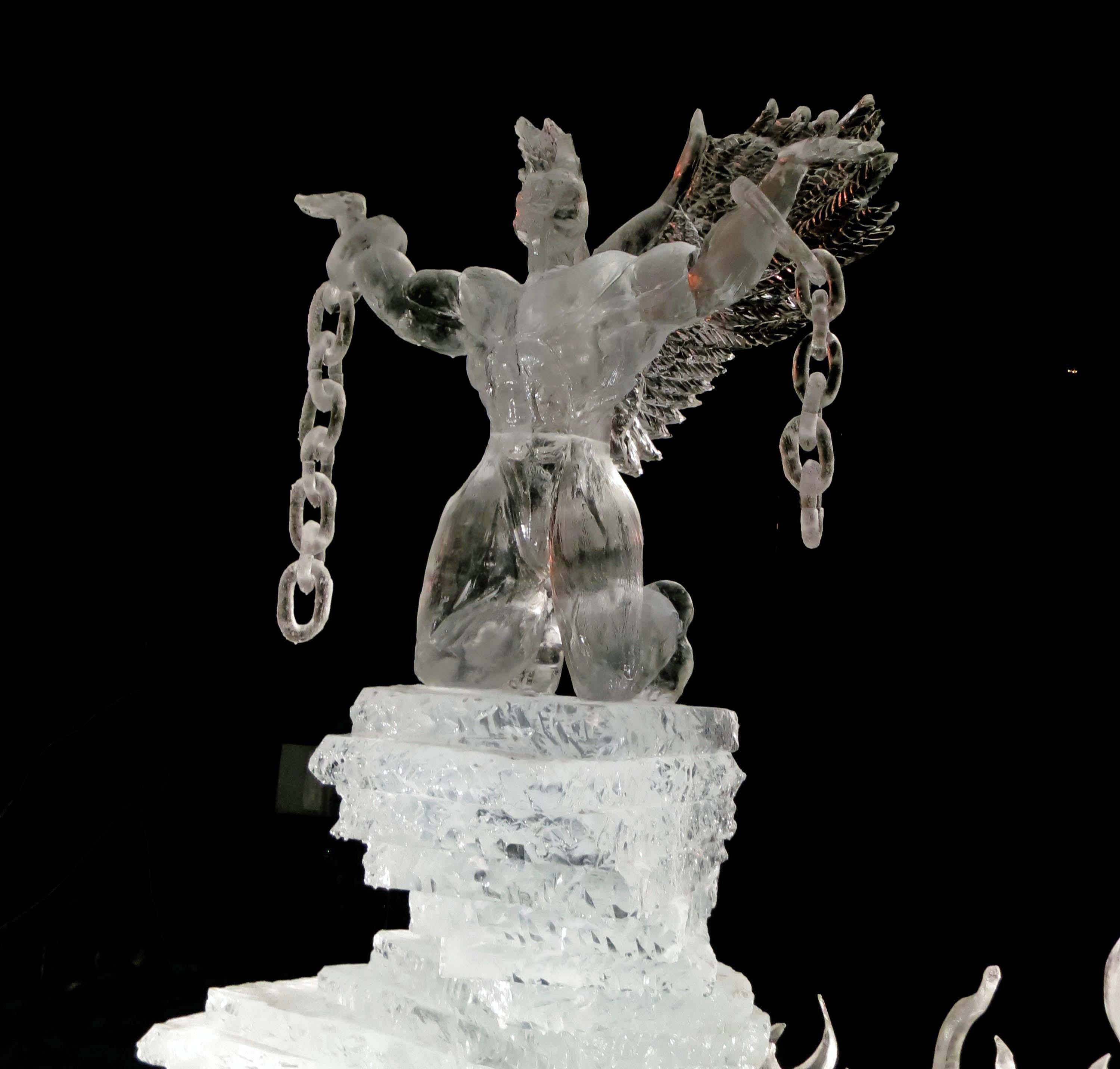 Night photo of sculpture "Still I Rise" at the 2016 Word Ice Art Championships in Fairbanks.