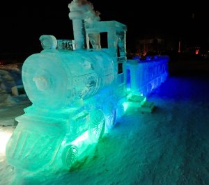 Ice sculptures, such as this train carved out of ice, are lit up at night at the Fairbanks Ice Park.