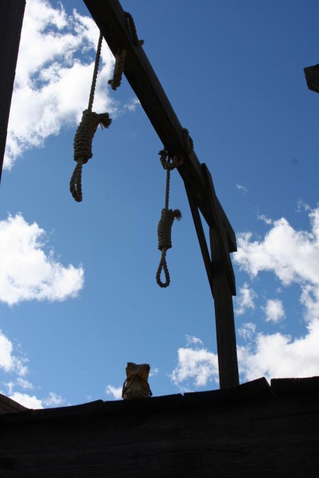 Bone faces the gallows in Tombstone, Arizona. He'd been cheating at cards, hanging out with loose women, and robbed a bank.