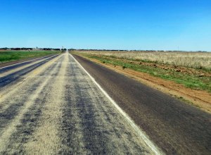 A water tower seen in the distance marking the town of Plains, Texas.