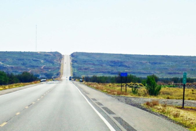My roads in the west were always disappearing over the horizon. This is New Mexico 380 dropping down into the Pecos river and climbing out the other side.