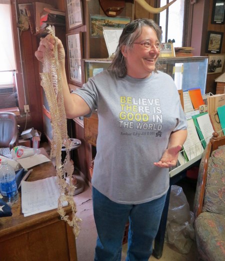 Mary Ann Levy holds up the snakeskin from the six-foot rat snake she found in the museum's toilet. 