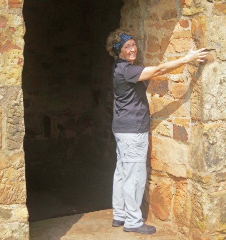 Peggy demonstrates the thickness of the ammunition magazine at the fort.