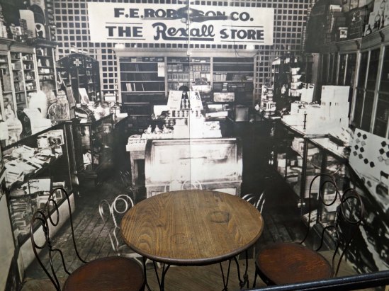 The actual table where the business leaders of Dayton plotted out the steps that would lead to the Scopes Trial. The background photograph is of Robinson's drug store where they met with John Scopes.