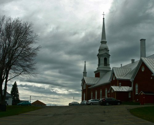 I liked the backdrop provided by the dark clouds with the churches cross caught in the sunlight.