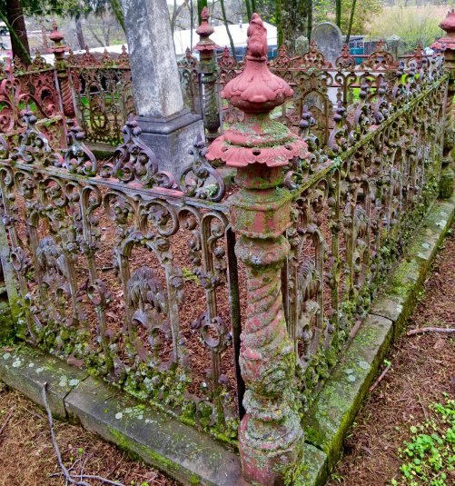 The fancier graves were surrounded by wrought iron fences like this one. We would swing on their gates, which would give off a satisfying Graveyard squeak. You can see our house beyond the fence.