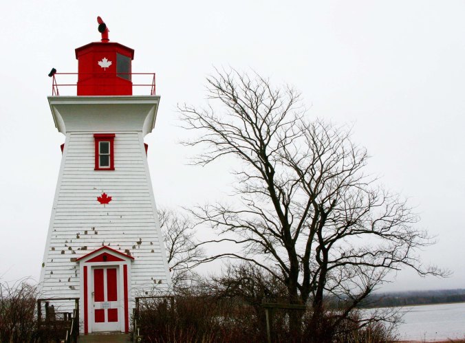 Grey skies detracted from the "picture postcard" look this lighthouse in Victoria, Prince Edward Island is supposed to have, but provided a powerful backdrop for the tree that seems to lean toward it.