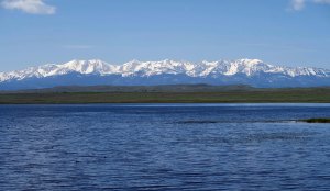 Rocky Mountains behind lake in Montana.