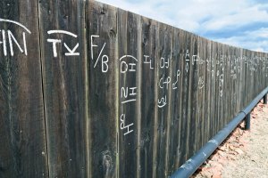 Fence showing Montana cattle brands at Culbertson, Montana museum.