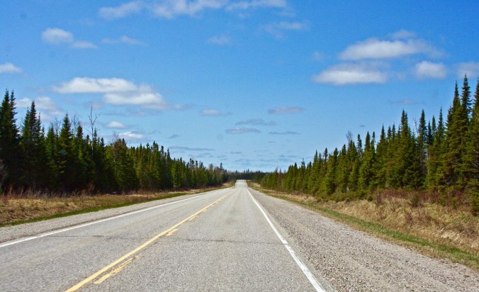 Trans-Canada Highway 11 works its way across Ontario— in this particular instance forested, flat and straight.