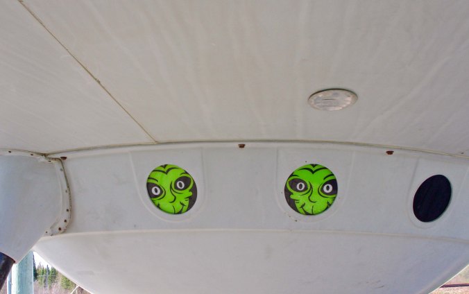 Aliens peak out window of flying saucer in front of information center in Moonbeam, Ontario Canada.