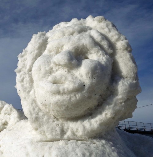 Back in Anchorage, we watched sled dog races. Warm temperatures meant they had to put down snow for the races. And it meant that this snow sculpture of a native Alaskan was melting. I still found it beautiful.