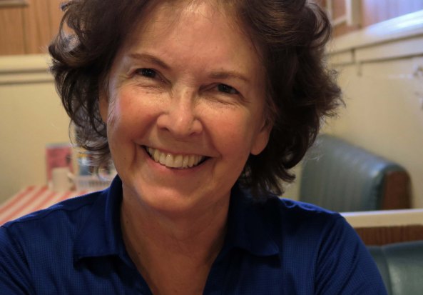 Peggy celebrating the end of re-tracing my bike route at the Diamond Springs hotel. She had driven our RV the whole way so I could take photos and notes. Still smiling!