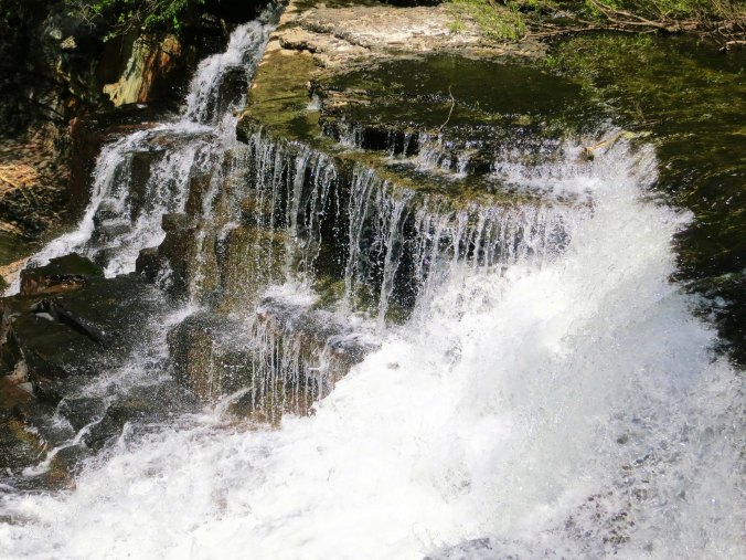 America and Canada are crammed with beautiful sights that range from mountains to deserts to oceans, to plains, to rivers... and well the list just goes on and on. This is a waterfall from Old Stone Fort State Park in Tennessee.