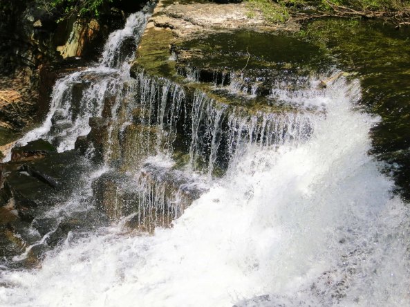 America and Canada are crammed with beautiful sights that range from mountains to deserts to oceans, to plains, to rivers... and well the list just goes on and on. This is a waterfall from Old Stone Fort State Park in Tennessee.