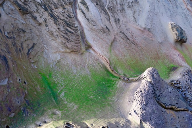 Sedimentary rock warn down by waves at Sunset Bay State Park on the Oregon Coast.