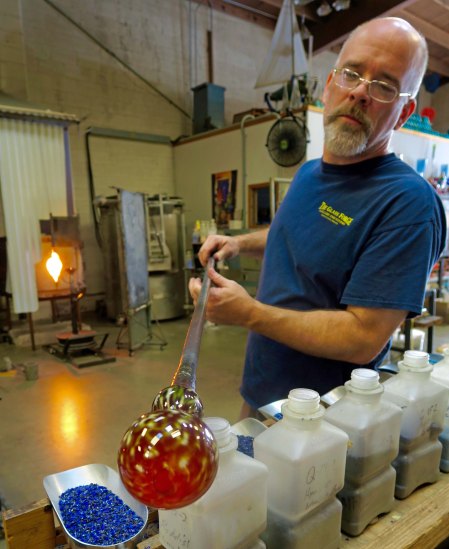 The Glass Forge of Grants Pass, Oregon was founded by Lee Wassink, shown above creating a vase.