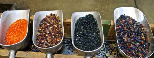 Bins that hold colored glass to add color to glass art created at the Glass Forge in Grants Pass, Oregon.
