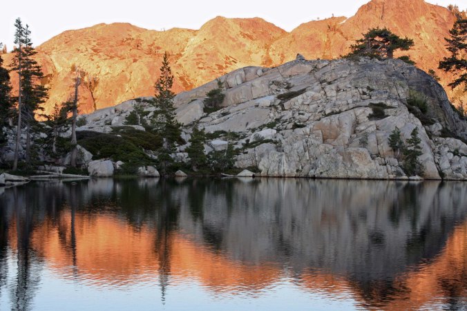 The Black Buttes of the Sierra Nevada Mountains are lit up by the evening sun.