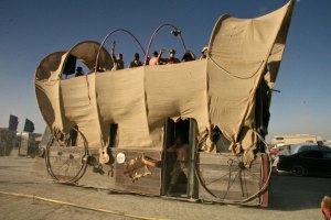 A covered wagon mutant vehicle at Burning Man.