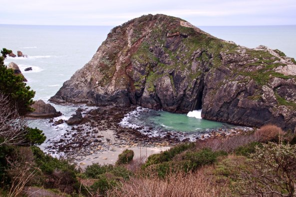 Split rock at Harris Beach State Park allows waves to go under rock.