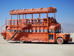 Orange mutant vehicle bus side view.