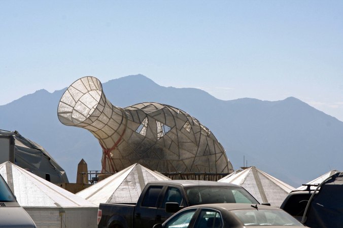 Vase mutant vehicle at Burning Man with mountain backdrop.