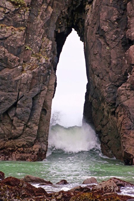 Down on the beach, Peggy caught a shot of a wave come through the split in the rock.