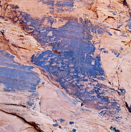 Petroglyphs carved into desert varnish on a cliff face near Atlatl Rock in Valley of Fire State Park near Las Vegas, Nevada.