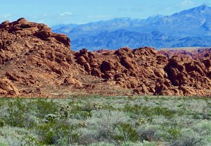 Red sandstone rocks and mountains at Valley of Fire State Park in Southern Nevada.