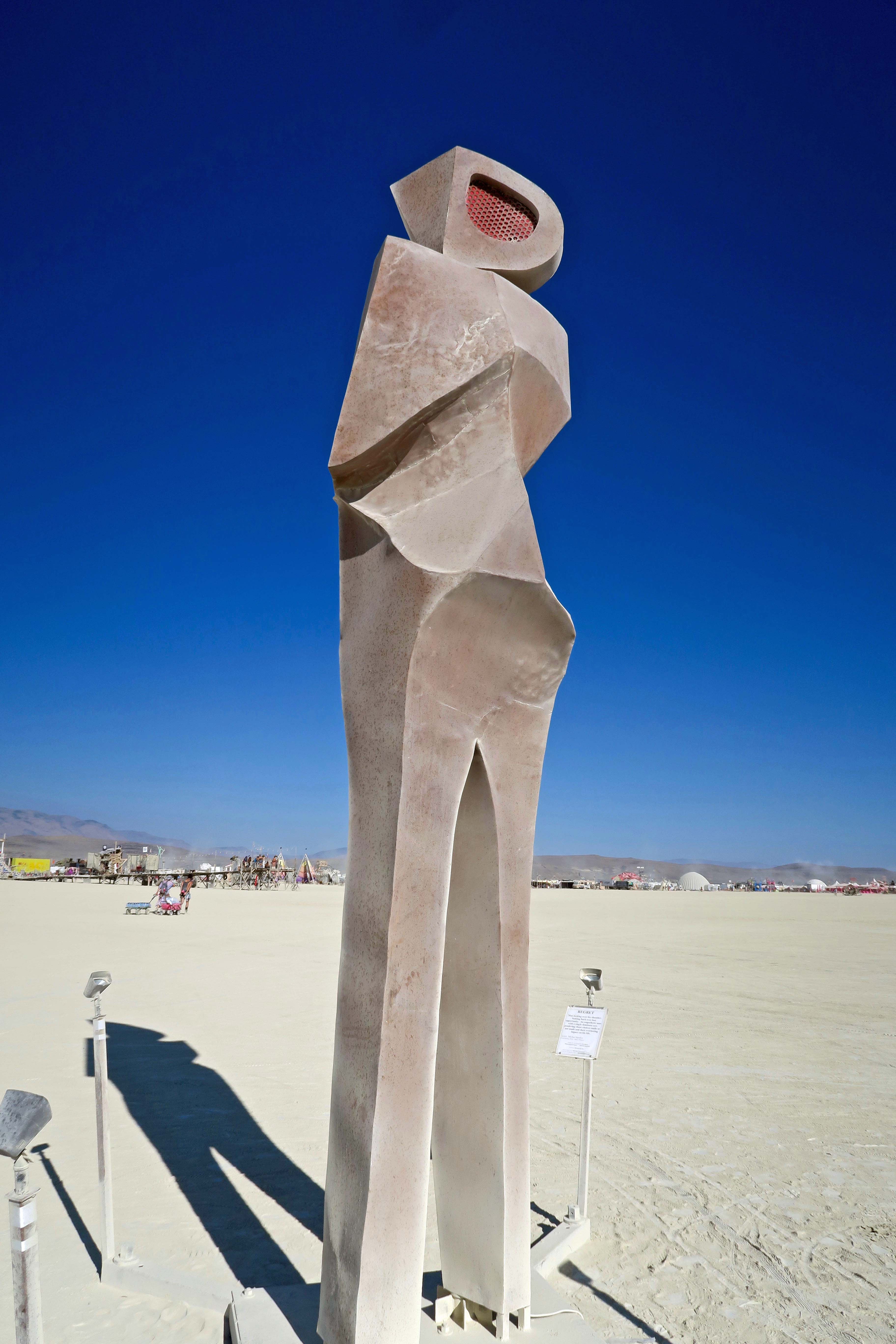 Man looking over shoulder sculpture at Burning Man 2017