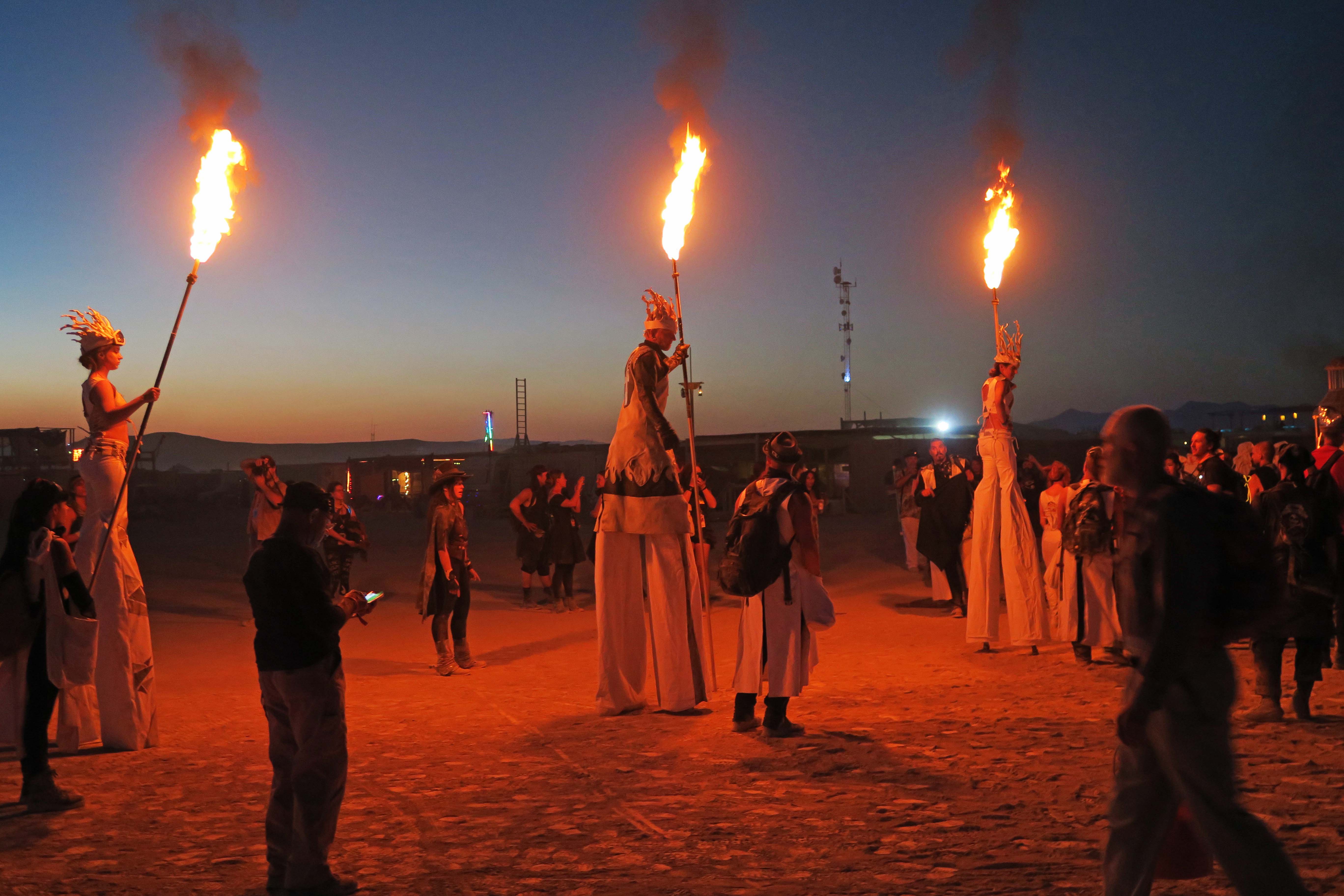 Stilt walkers on way to lighting of the Man, Burning Man 2017