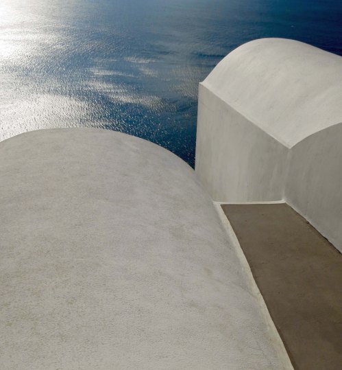 Photo of rounded buildings on Santorini overlooking Aegean Sea by Curtis Mekemson.