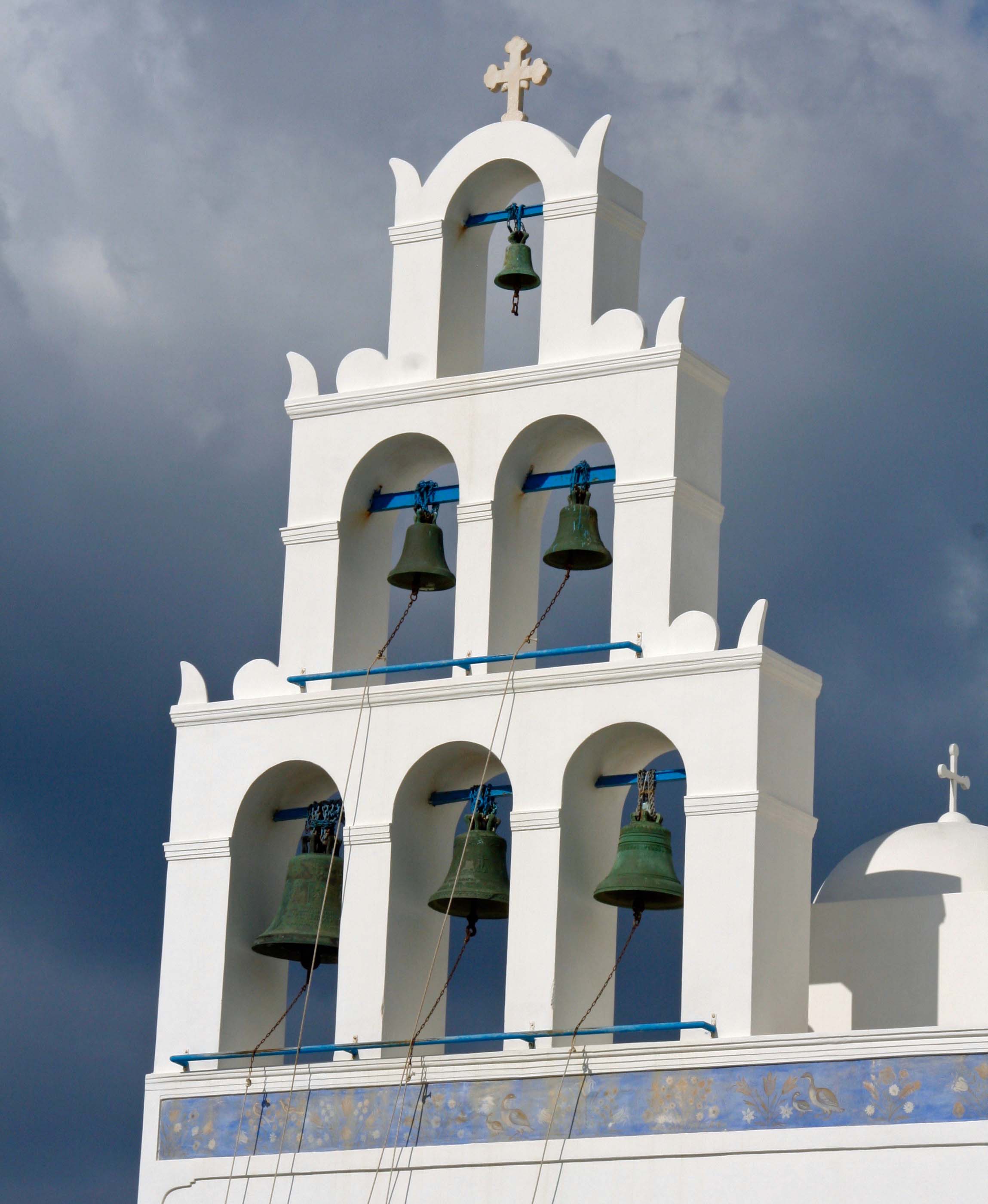 Church bells against dark sky in Santorini