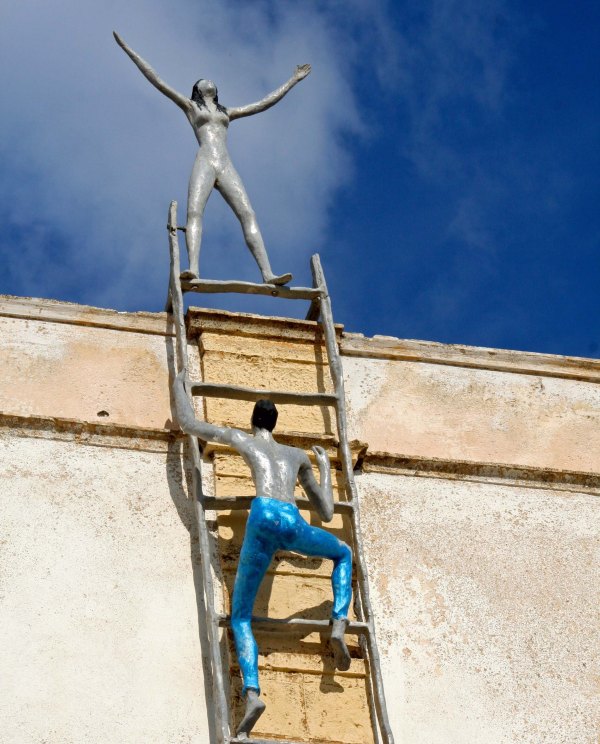 Climbing a ladder in Santorini