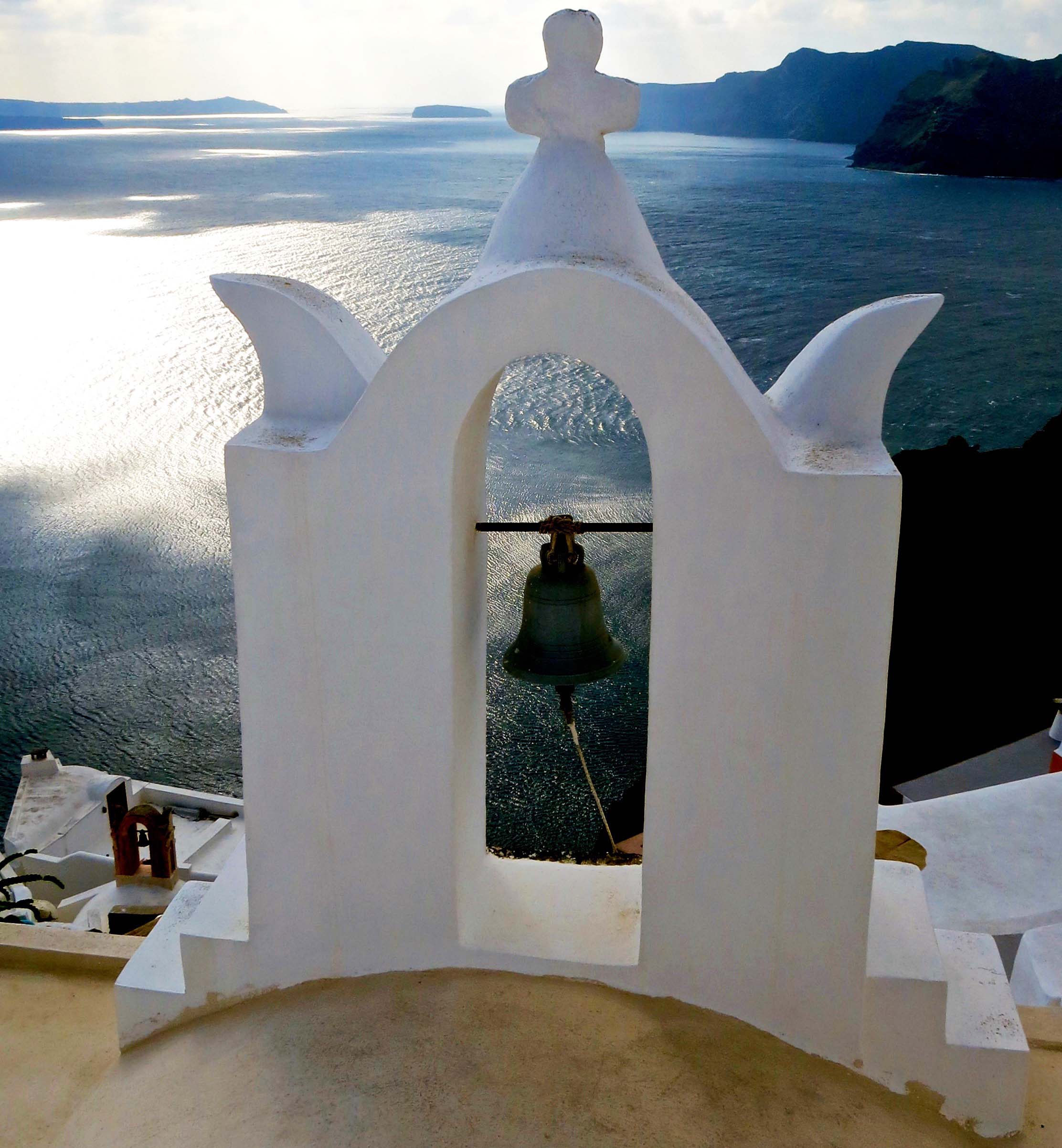 Bell on chapel looking out toward Aegean Sea on Island of Santorini. Photo by Curtis Mekemson.