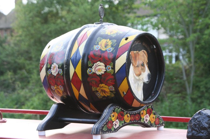 Narrow boat dog on barrel on Trent and Mercy Canal