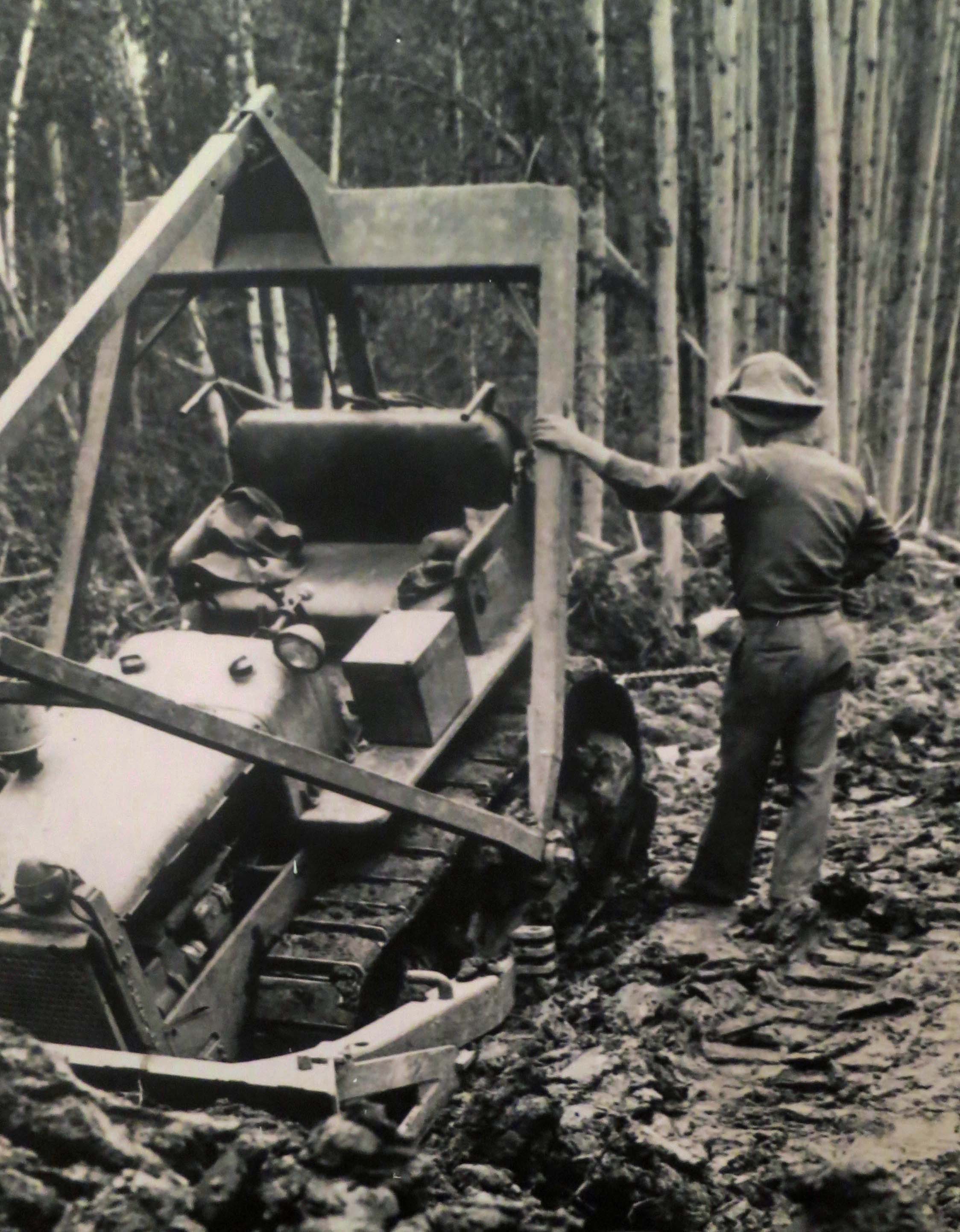 Bulldozer buried in mud while building the Alaska Highway