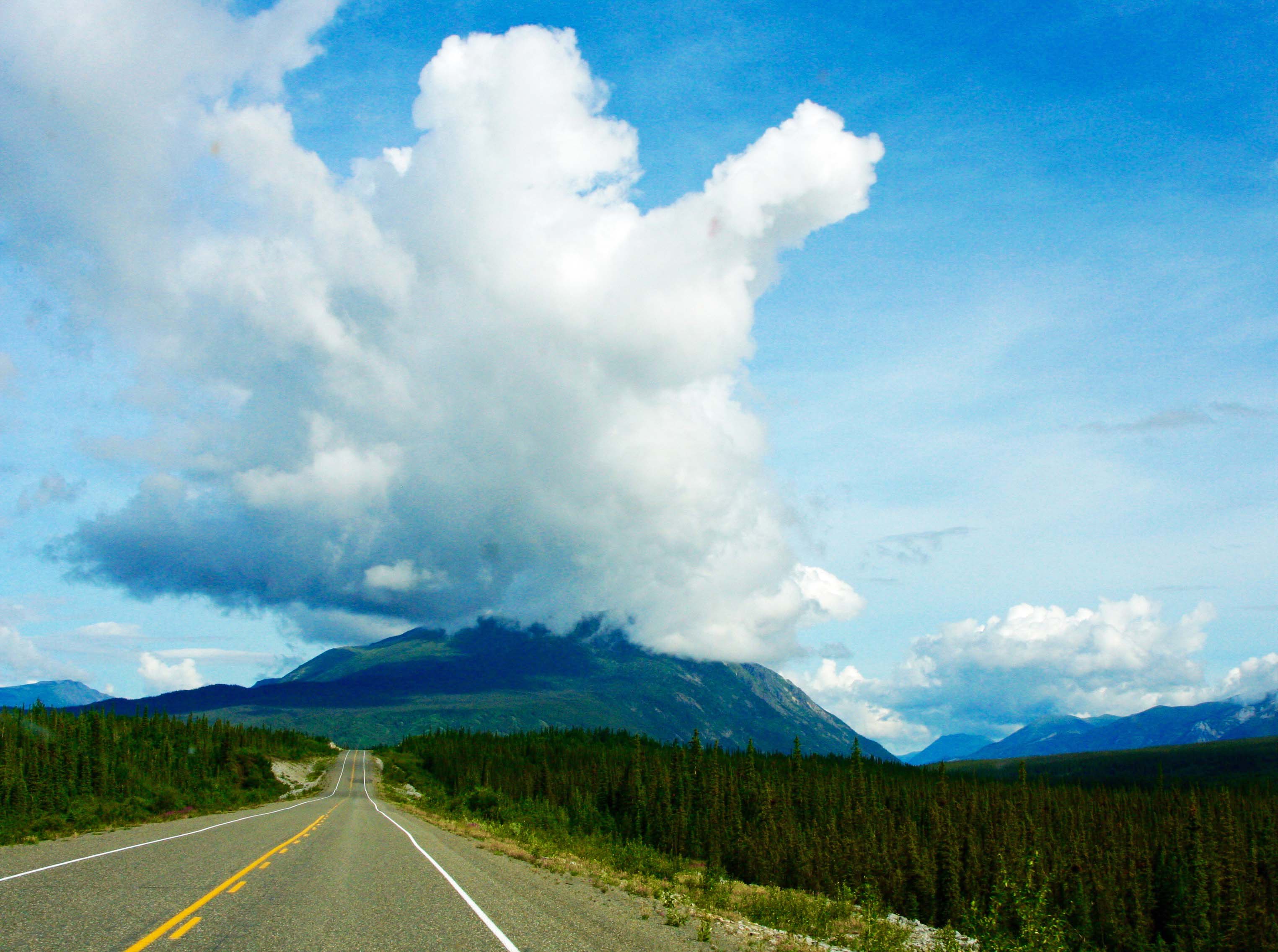 clouds and mountains along alaska highway