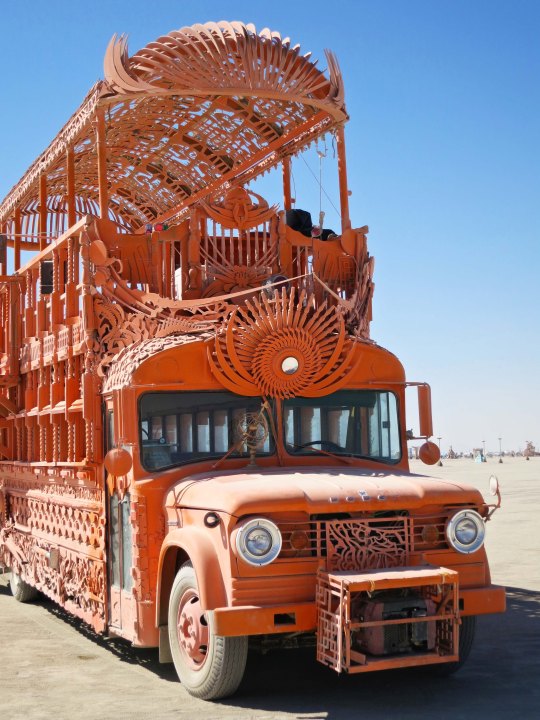 Orange mutant vehicle  bus at Burning Man.