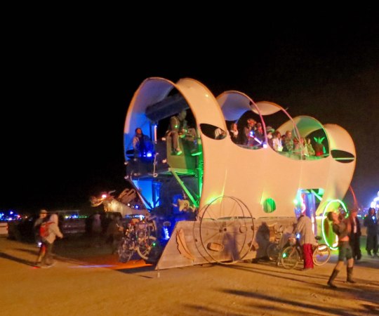 Conestoga Wagon mutant vehicle at Burning Man at night.