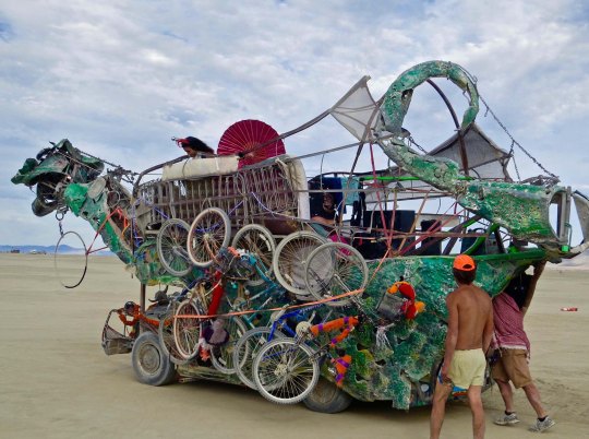 Bikes loaded on a green dragon mutant vehicle at Burning Man.