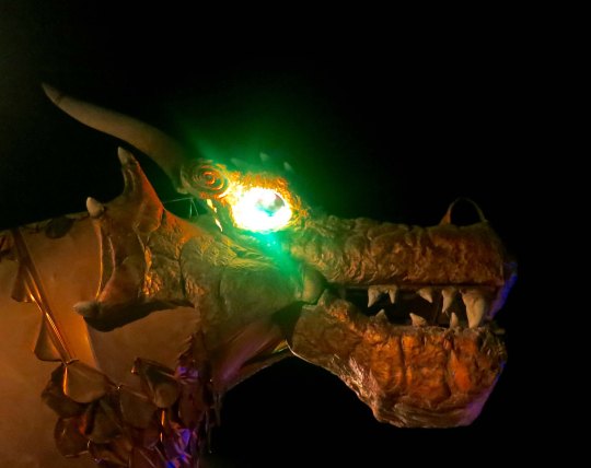 Mutant vehicle dragon with eyes glowing in the night at Burning Man.