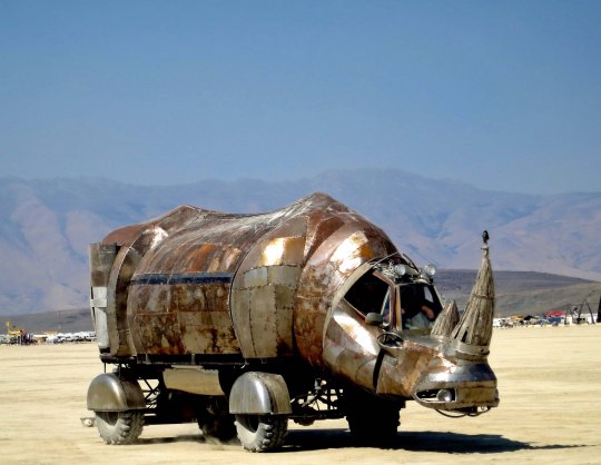 Large rhino mutant vehicle crosses the Playa at Burning Man.