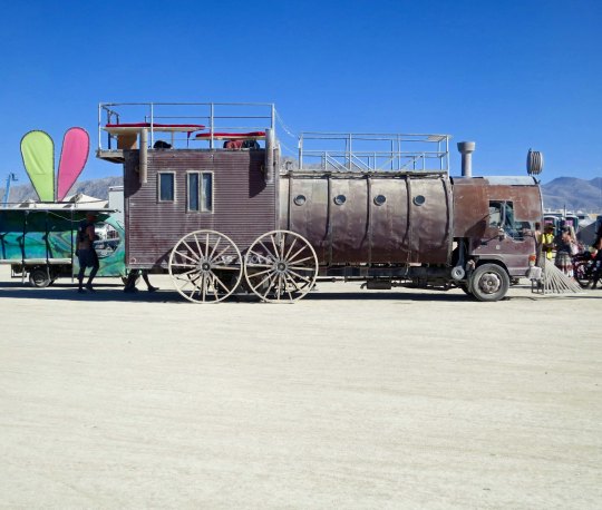 Side view of mutant vehicle train at Burning Man.