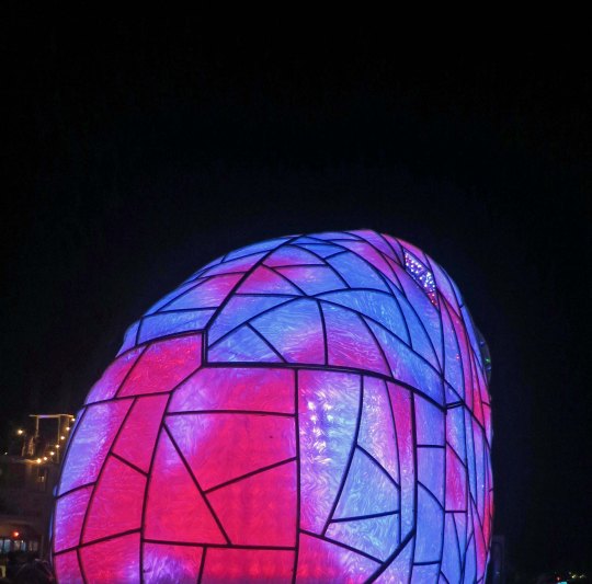 Nighttime view of mutant vehicle vase at Burning Man.